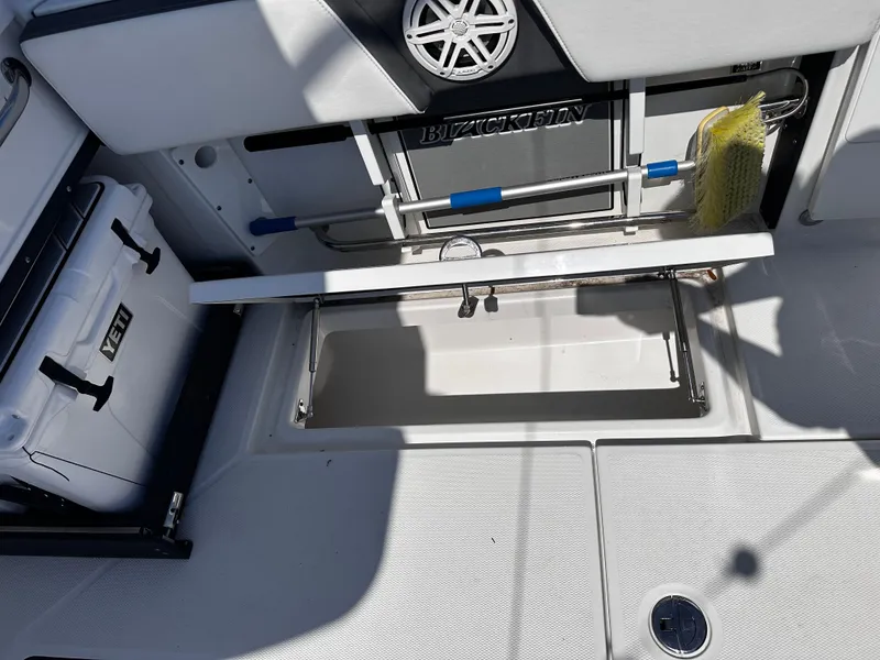 Slide: The Image of 2021 Blackfin 252 DC boat with open storage compartment and Yeti cooler. - 33