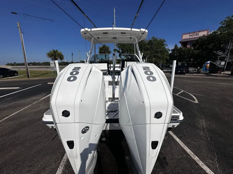 Slide: The Image of 2021 Blackfin 252 DC boat with twin 200 horsepower engines in a parking lot. - 8