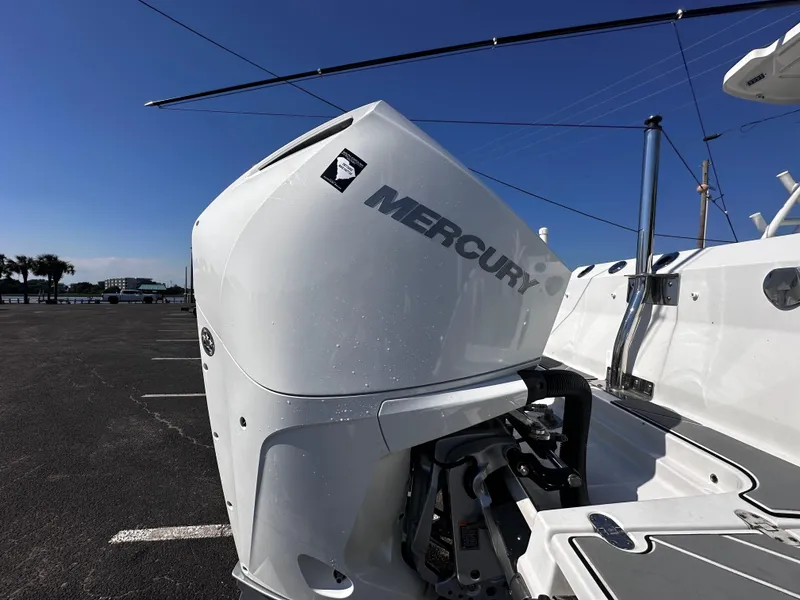 Slide: The Image of 2021 Blackfin 252 DC with Mercury outboard engine in a parking lot. - 9