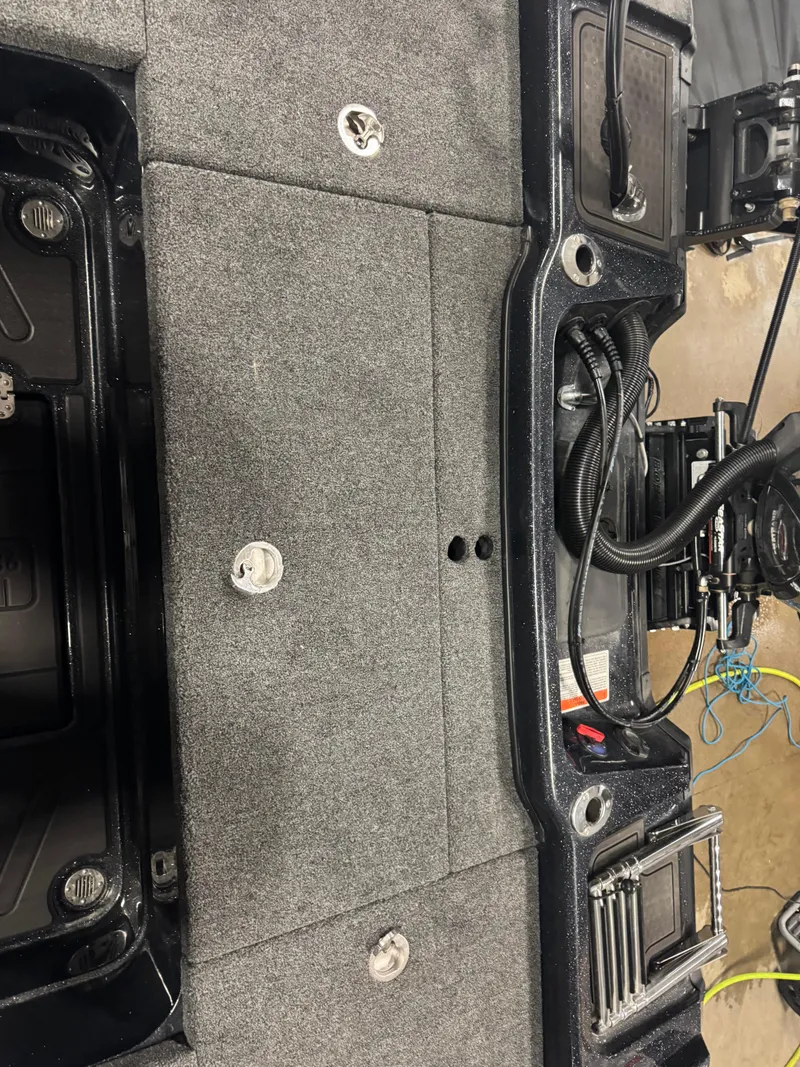 Slide: The Image of 2024 Nitro ZV20 Pro boat interior with gray carpet and visible wiring. - 11