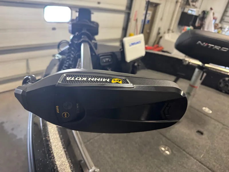 Slide: The Image of 2024 Nitro ZV20 Pro boat with Minn Kota trolling motor in a garage setting. - 18