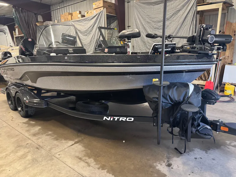 Slide: The Image of 2024 Nitro ZV20 Pro fishing boat in a garage, featuring advanced equipment and sleek design. - 2