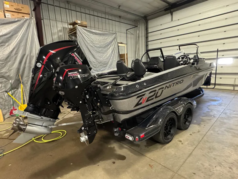 Slide: The Image of 2024 Nitro ZV20 Pro boat in garage, featuring Mercury Pro Kicker engine. - 3