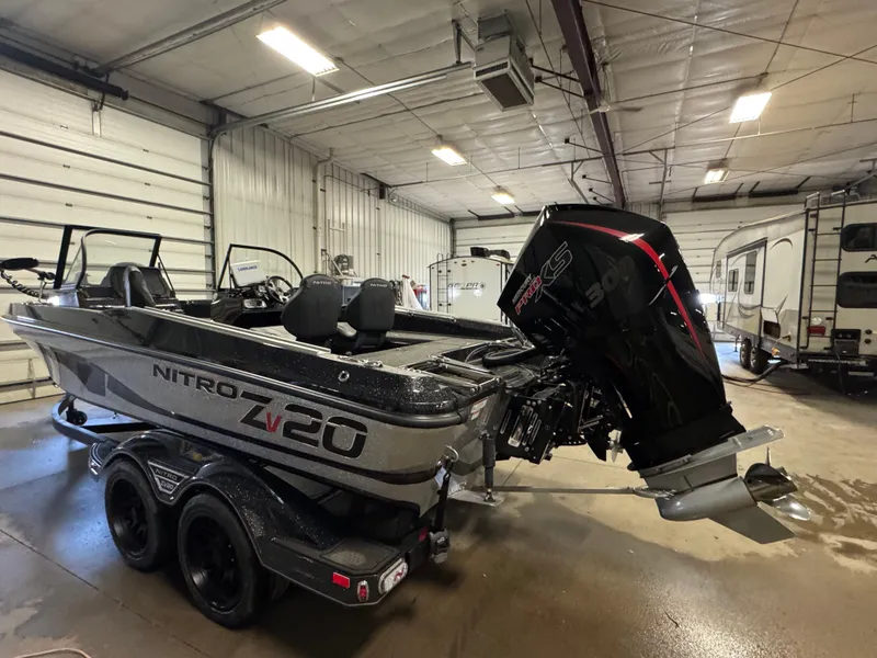 Slide: The Image of 2024 Nitro ZV20 Pro boat in a garage, featuring a powerful engine and sleek design. - 4