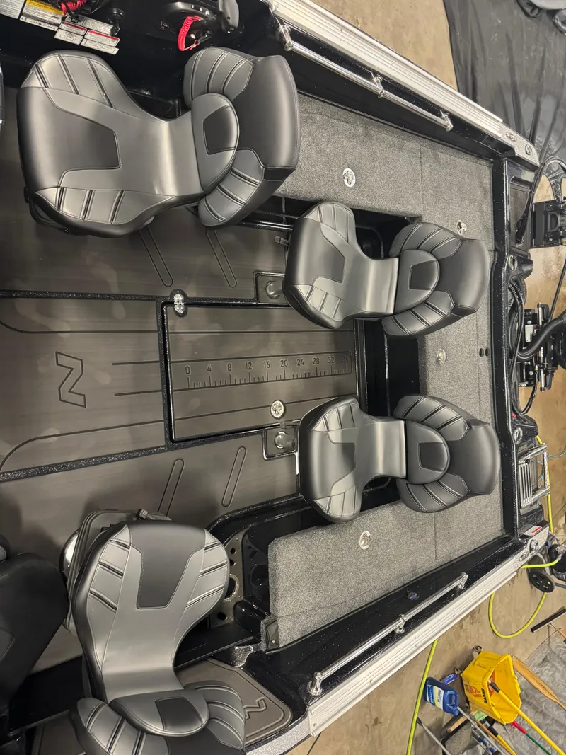 Slide: The Image of 2024 Nitro ZV20 Pro boat interior with four sleek black seats and a measuring ruler. - 6