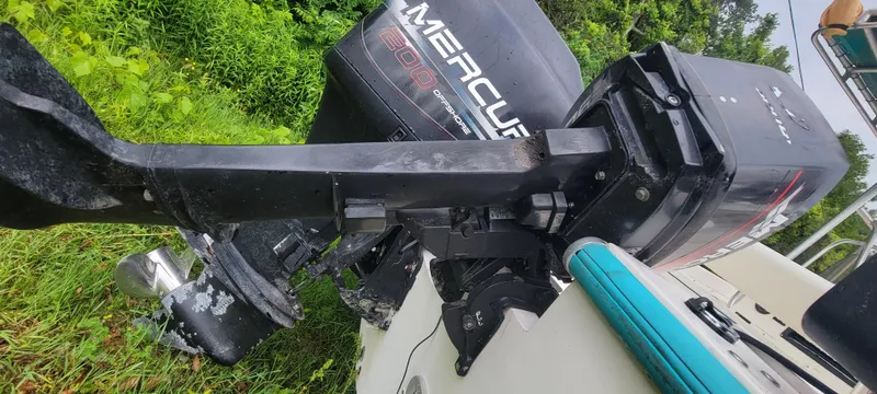 Slide: The Image of Outboard motor on a 1996 Mako 22 Center Console boat, surrounded by greenery. - 11