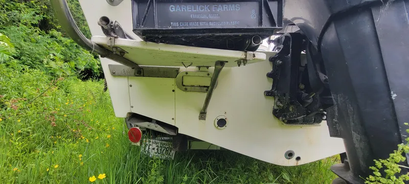 Slide: The Image of Rear view of a 1996 Mako 22 Center Console boat in grassy area. - 12