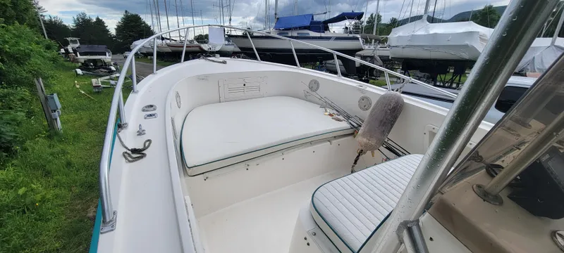 Slide: The Image of 1996 Mako 22 Center Console boat with white seating, docked outdoors. - 16