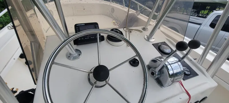 Slide: The Image of 1996 Mako 22 Center Console boat steering wheel and controls. - 17