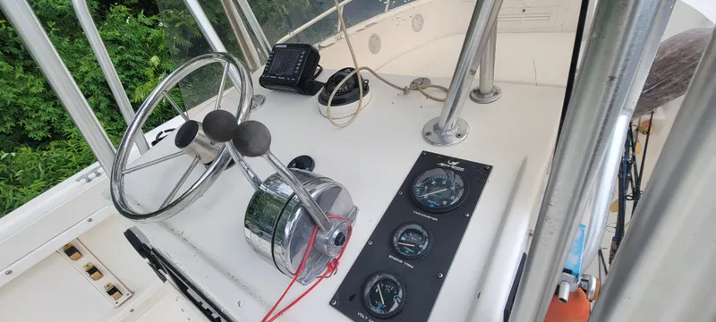 Slide: The Image of 1996 Mako 22 Center Console boat dashboard with steering wheel and gauges. - 18