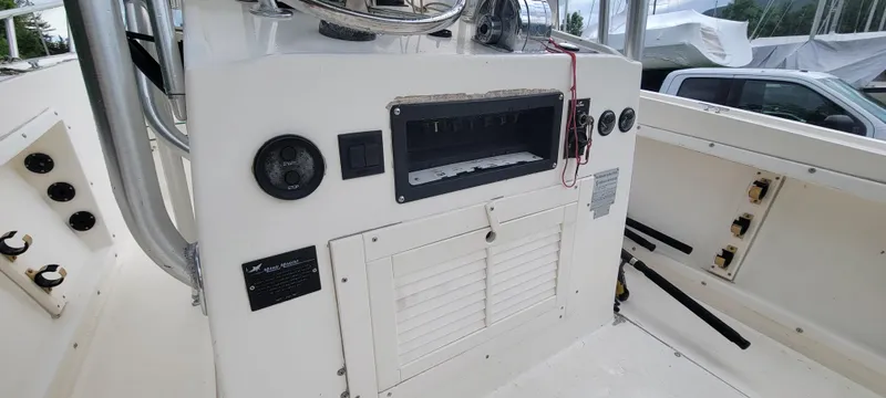 Slide: The Image of 1996 Mako 22 Center Console boat interior with control panel and storage compartments. - 19