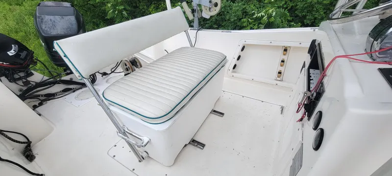 Slide: The Image of 1996 Mako 22 Center Console boat interior with white seating and control panel. - 21