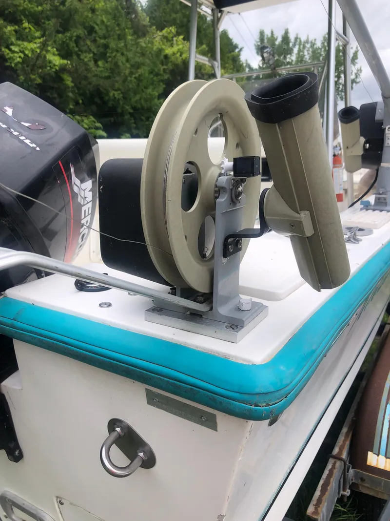 Slide: The Image of 1996 Mako 22 Center Console boat with fishing rod holders and Mercury outboard motor. - 27