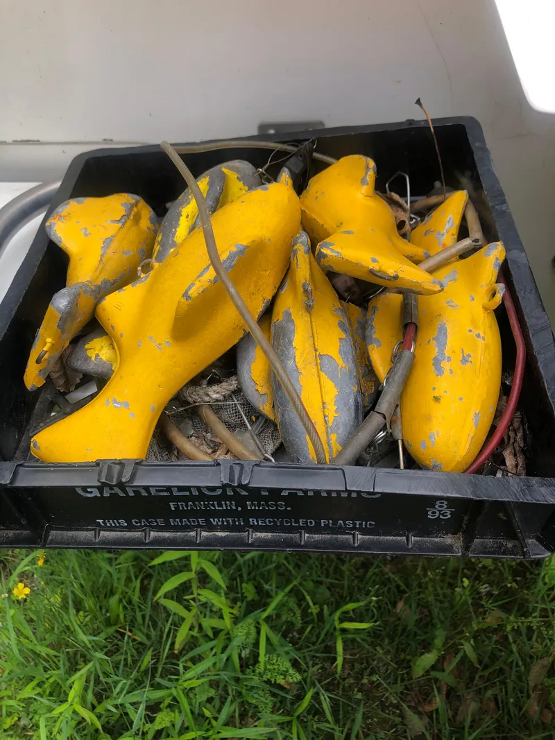 Slide: The Image of Yellow boat fenders in a black crate on grass, Mako 22 Center Console, 1996. - 29