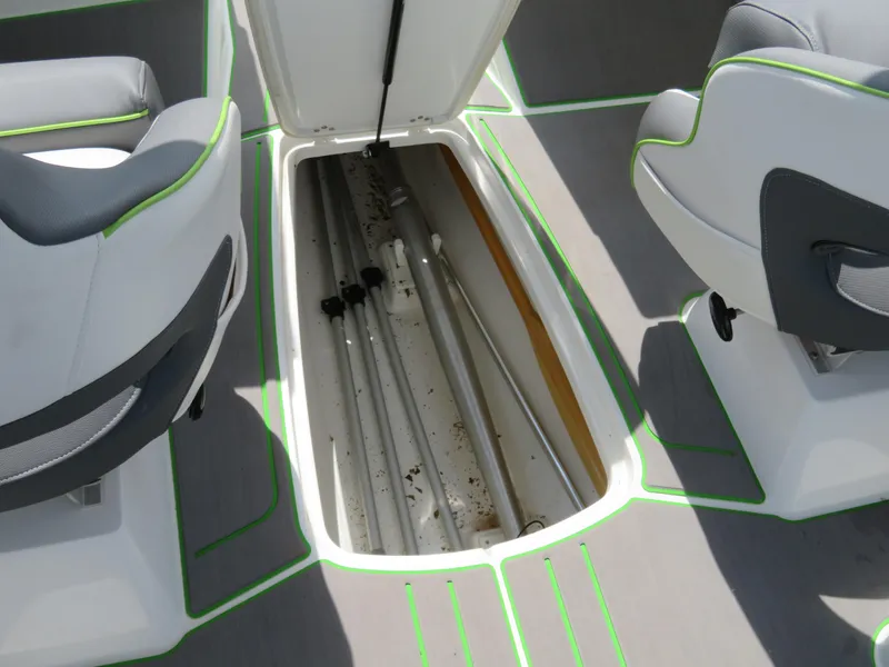 Slide: The Image of 2022 Tahoe 210 S Limited boat storage compartment between seats. - 18