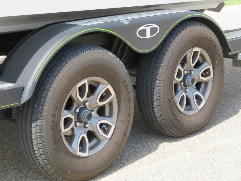 Slide: The Image of 2022 Tahoe 210 S Limited trailer wheels and tires close-up. - 20