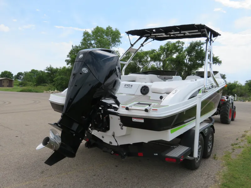 Slide: The Image of 2022 Tahoe 210 S Limited boat with outboard motor on trailer. - 3