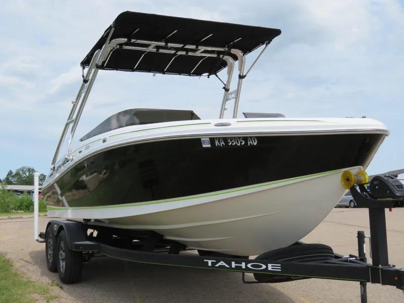 Slide: The Image of 2022 Tahoe 210 S Limited boat on trailer with black and white exterior. - 4