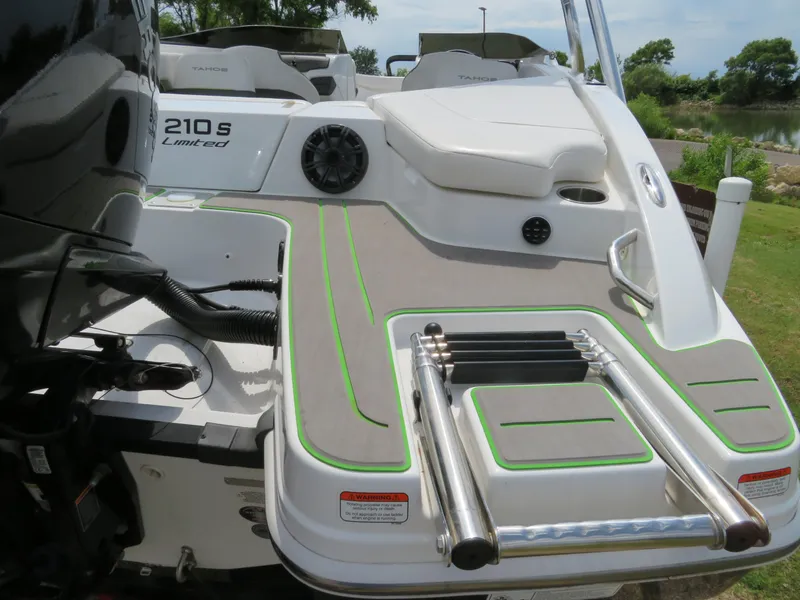 Slide: The Image of 2022 Tahoe 210 S Limited boat with swim platform and ladder. - 5