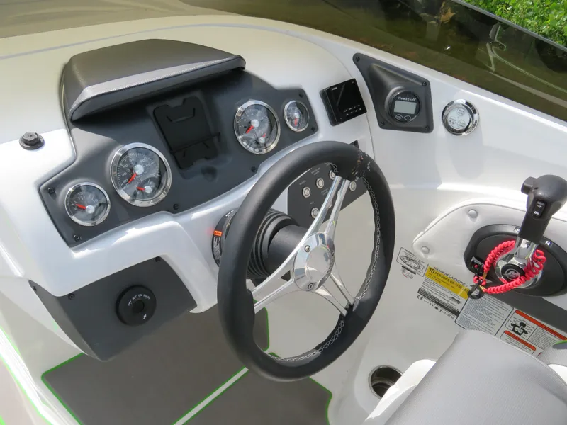 Slide: The Image of 2022 Tahoe 210 S Limited boat dashboard with steering wheel and control panel. - 9