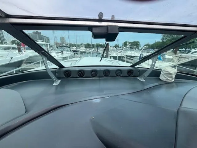 Slide: The Image of Interior view of a 1992 Sea Ray Sundancer boat docked at a marina. - 10