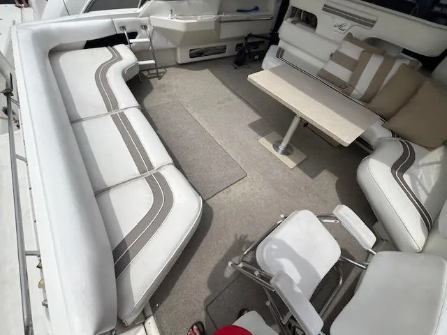 Slide: The Image of 1992 Sea Ray Sundancer boat interior with white seating and table. - 13