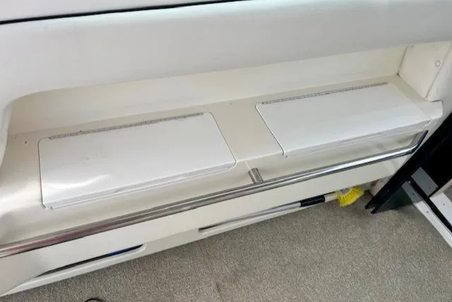 Slide: The Image of 1992 Sea Ray Sundancer interior storage compartments and seating area. - 14