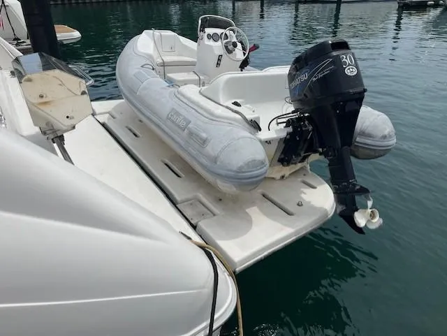 Slide: The Image of 1992 Sea Ray Sundancer with inflatable dinghy and outboard motor on swim platform. - 16