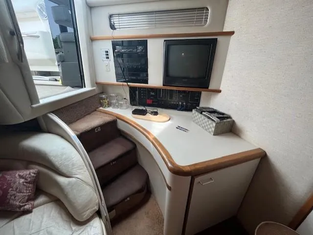 Slide: The Image of 1992 Sea Ray Sundancer cabin interior with TV, stereo, and storage. - 18
