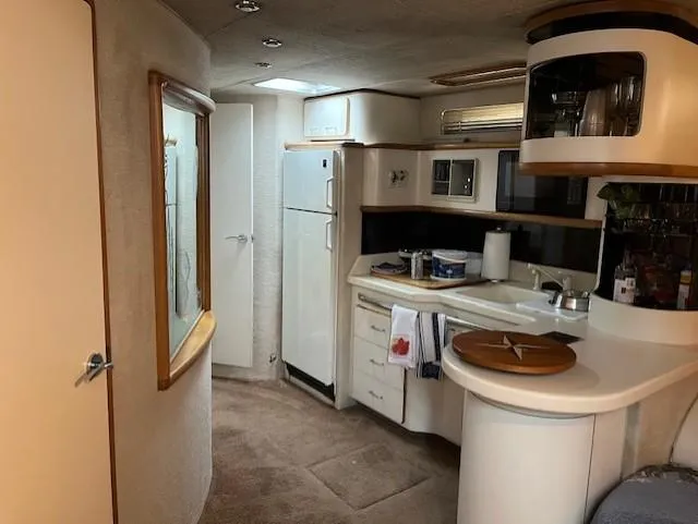 Slide: The Image of Interior of a 1992 Sea Ray Sundancer yacht with kitchen and appliances. - 2