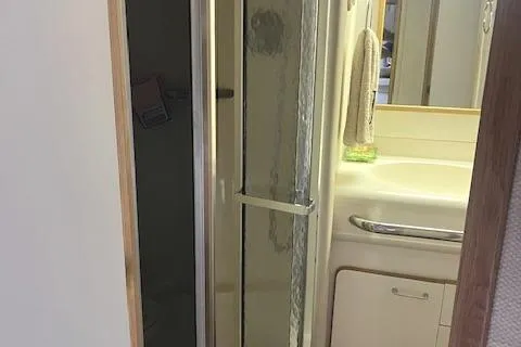 Slide: The Image of 1992 Sea Ray Sundancer bathroom with shower and sink. - 28