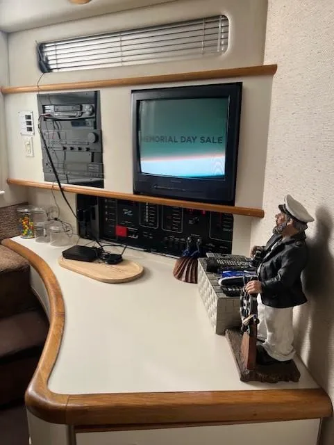 Slide: The Image of 1992 Sea Ray Sundancer interior with TV, control panel, and nautical decor. - 31