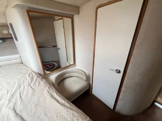 Slide: The Image of Interior cabin of 1992 Sea Ray Sundancer with bed, mirror, and door. - 32