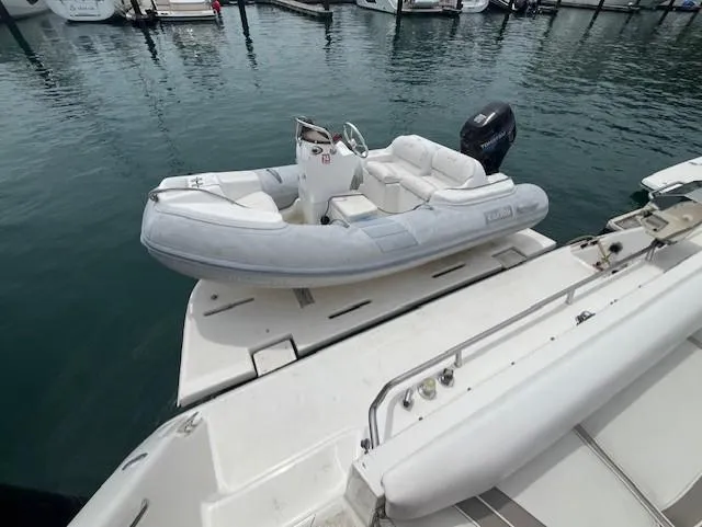 Slide: The Image of 1992 Sea Ray Sundancer with inflatable dinghy at marina. - 4