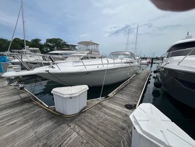 Slide: The Image of 1992 Sea Ray Sundancer yacht docked at a marina on a sunny day. - 7