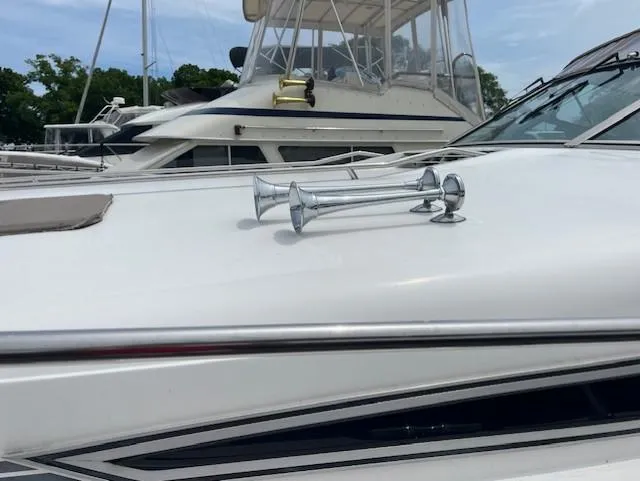 Slide: The Image of 1992 Sea Ray Sundancer boat with chrome horns docked at marina. - 8