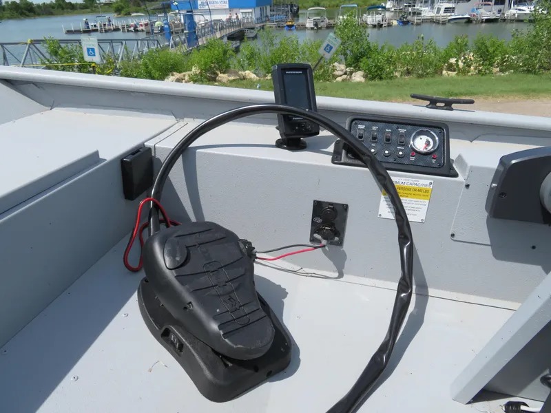 Slide: The Image of 2023 G3 Sportsman 1610 SS boat dashboard with steering wheel and control panel. - 3