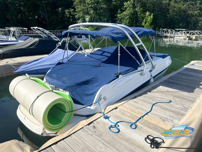 Slide: The Image of 2006 Chaparral Sunesta 236 boat docked with blue cover and green float. - 10