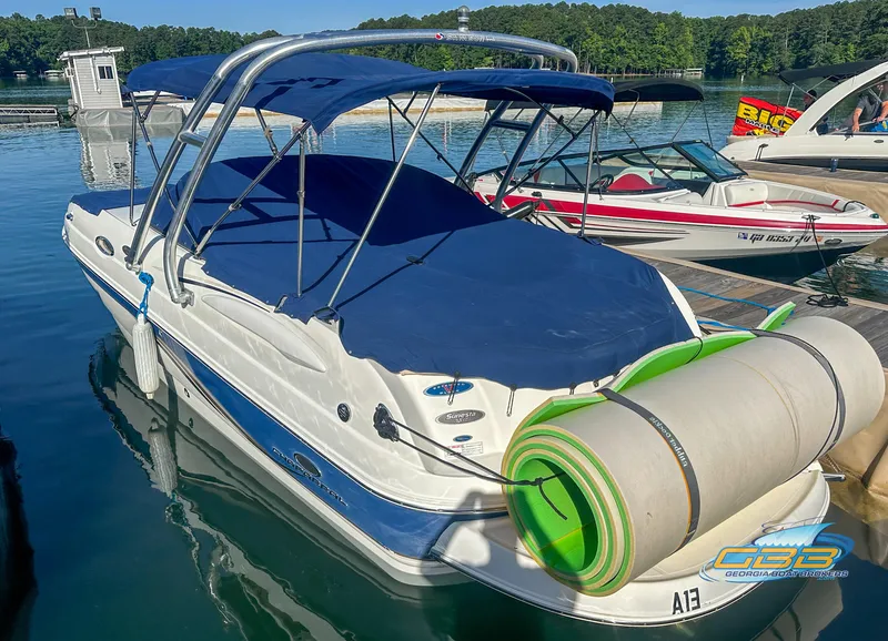 Slide: The Image of 2006 Chaparral Sunesta 236 boat docked with blue canopy and rolled-up mat. - 11