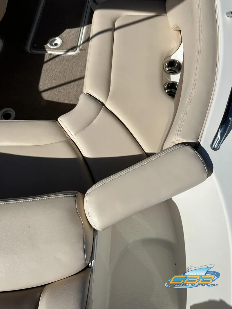 Slide: The Image of 2006 Chaparral Sunesta 236 boat interior seating with beige upholstery. - 12