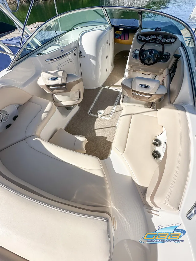 Slide: The Image of 2006 Chaparral Sunesta 236 boat interior with beige seating and dashboard. - 13