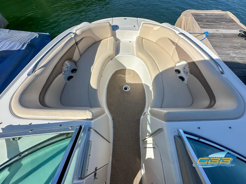 Slide: The Image of 2006 Chaparral Sunesta 236 boat interior with beige seating and carpeted floor. - 16
