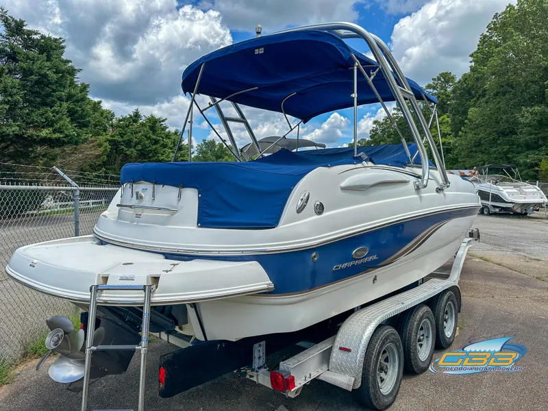 Slide: The Image of 2006 Chaparral Sunesta 236 boat on a trailer with blue canopy. - 2