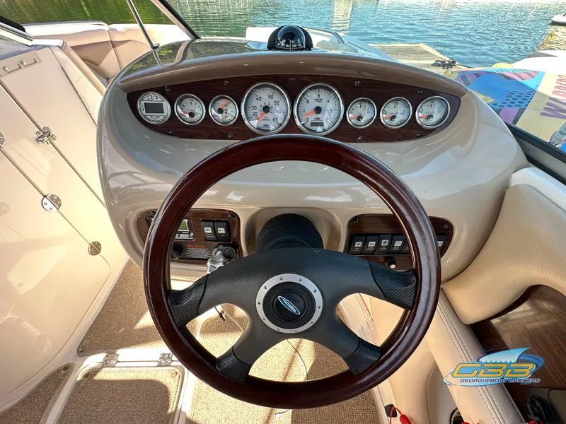 Slide: The Image of 2006 Chaparral Sunesta 236 boat dashboard with steering wheel and gauges. - 22