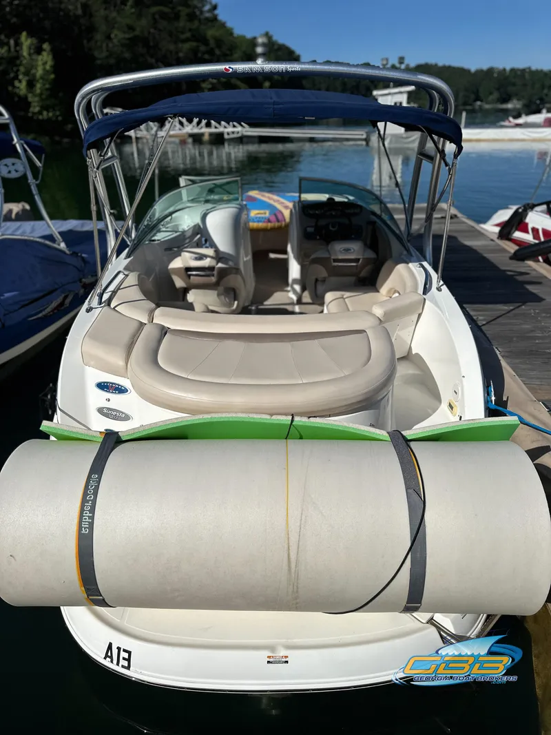 Slide: The Image of 2006 Chaparral Sunesta 236 boat docked with a rolled-up inflatable tube. - 23