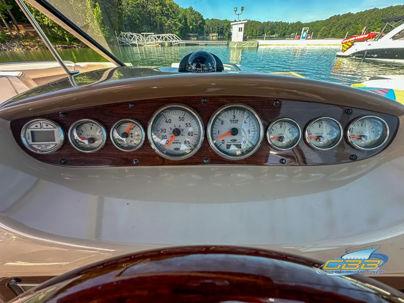 Slide: The Image of 2006 Chaparral Sunesta 236 dashboard with gauges at a marina. - 24
