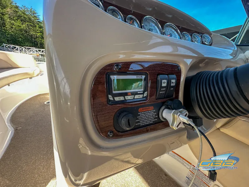 Slide: The Image of 2006 Chaparral Sunesta 236 boat dashboard with control panel and gauges. - 25