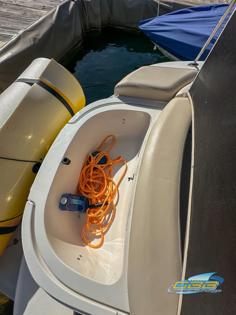 Slide: The Image of 2006 Chaparral Sunesta 236 boat with storage compartment and orange rope. - 34
