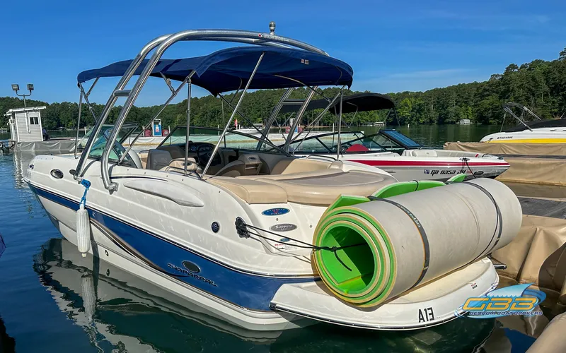 Slide: The Image of 2006 Chaparral Sunesta 236 boat docked with blue canopy and rolled-up water mat. - 7