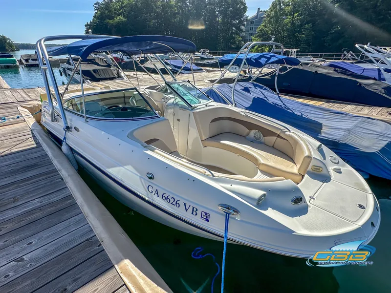 Slide: The Image of 2006 Chaparral Sunesta 236 boat docked at marina with blue canopy. - 8